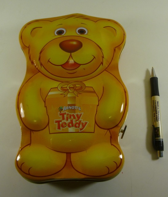 ARNOTT'S Tiny Teddy 'Happy', Musical 250g. Teddy-shaped Biscuit Tin, c.2005